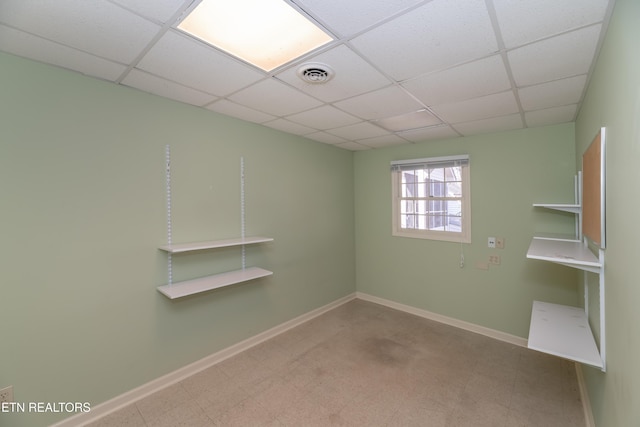 unfurnished room with a paneled ceiling