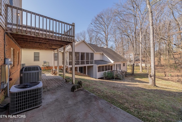 exterior space featuring cooling unit, a deck, a patio area, and a sunroom