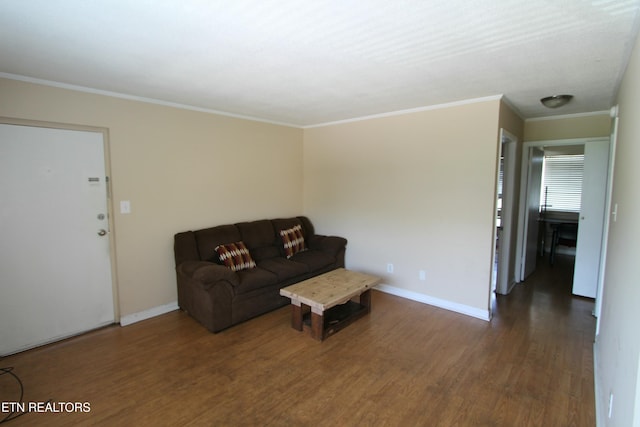 unfurnished living room with ornamental molding and dark hardwood / wood-style floors