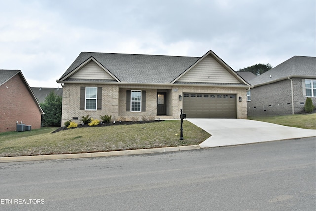 view of front of property with a garage, a front yard, and central AC unit