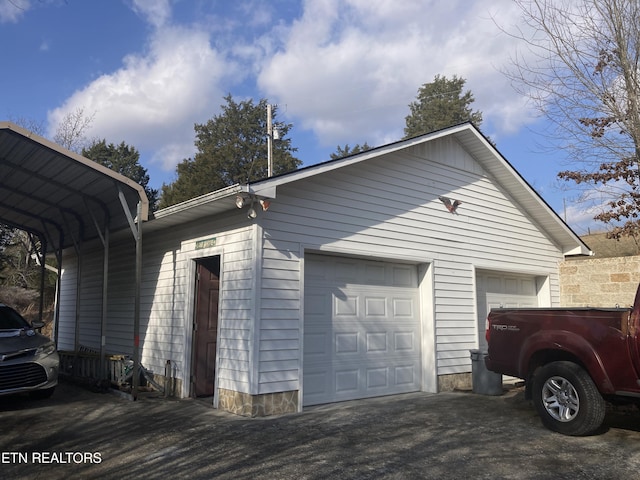 view of side of property featuring a carport and a garage