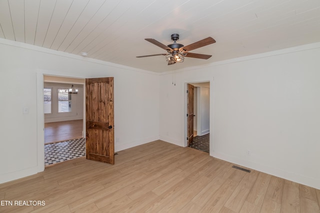 empty room featuring ornamental molding, ceiling fan with notable chandelier, wooden ceiling, and light hardwood / wood-style floors