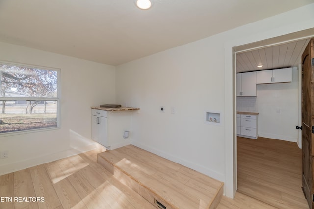 laundry room featuring washer hookup, hookup for an electric dryer, and light hardwood / wood-style floors