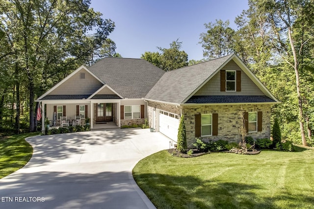 craftsman-style house with a porch, a garage, and a front lawn