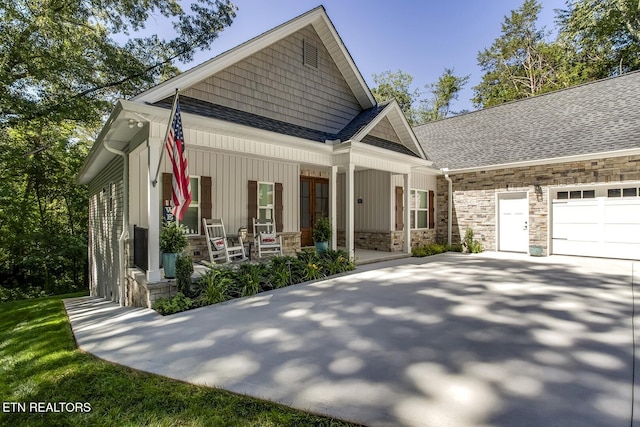 craftsman-style home with a garage and covered porch