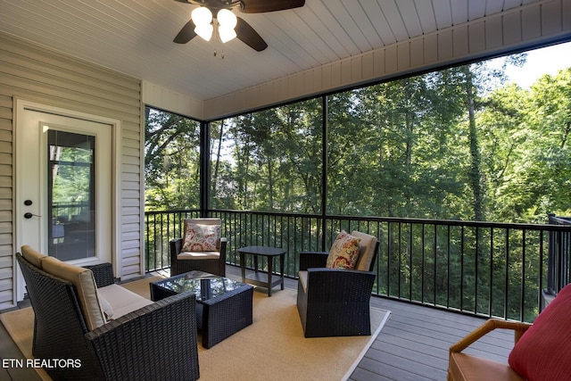 sunroom / solarium featuring ceiling fan