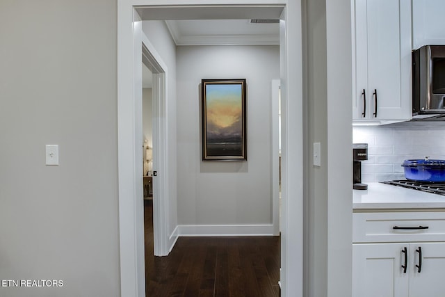 hall with crown molding and dark hardwood / wood-style floors