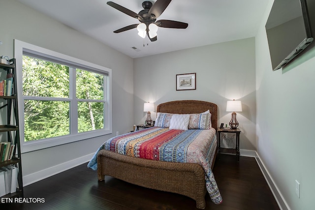 bedroom with ceiling fan and dark hardwood / wood-style floors