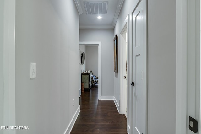 hallway with dark hardwood / wood-style flooring and crown molding