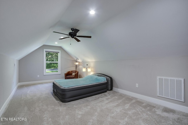 bedroom featuring vaulted ceiling, light carpet, and ceiling fan