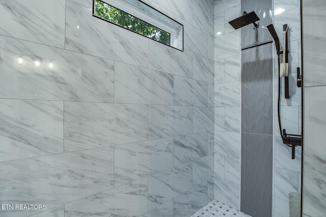 bathroom with a tile shower