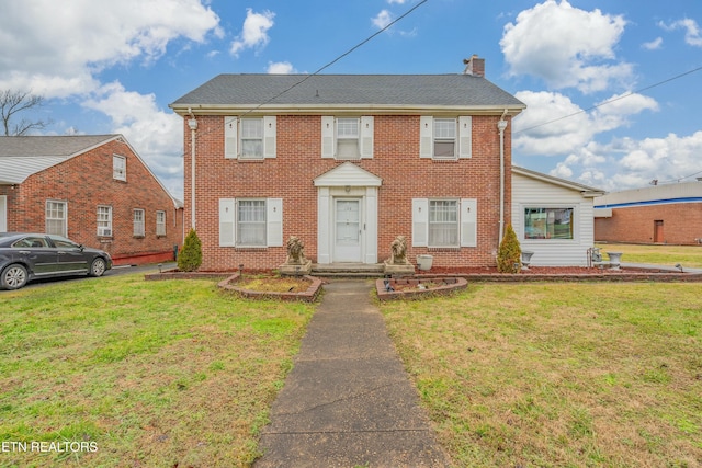 colonial-style house with a front lawn