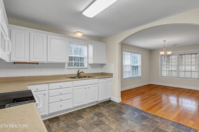 kitchen featuring sink, decorative light fixtures, dark hardwood / wood-style floors, white appliances, and white cabinets