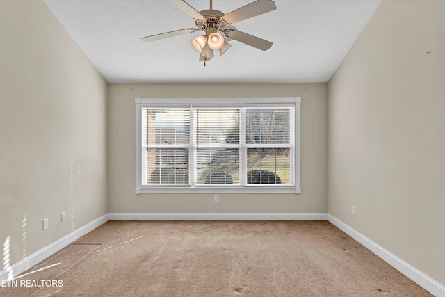 empty room featuring light carpet, a textured ceiling, and ceiling fan