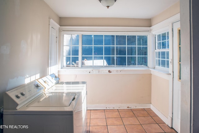 washroom with light tile patterned floors and washer and dryer