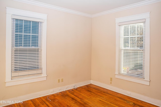 unfurnished room featuring ornamental molding and hardwood / wood-style floors