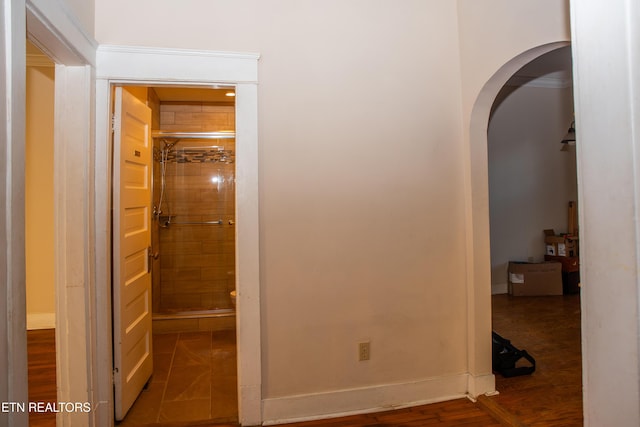 corridor with hardwood / wood-style flooring