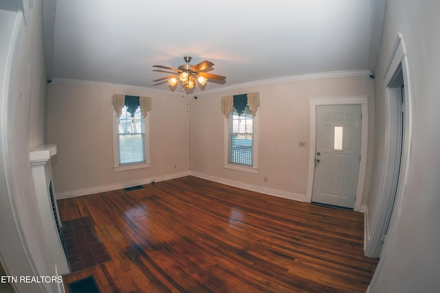 unfurnished living room with ceiling fan, ornamental molding, and dark hardwood / wood-style flooring