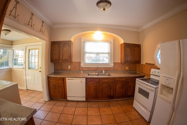 kitchen with light tile patterned flooring, sink, white appliances, and decorative backsplash