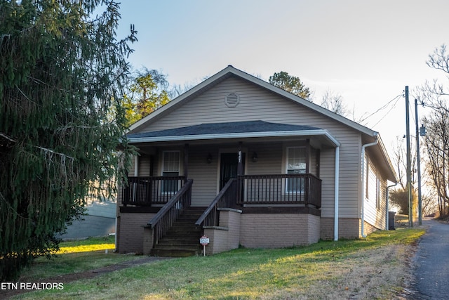 bungalow-style home featuring a front yard and a porch