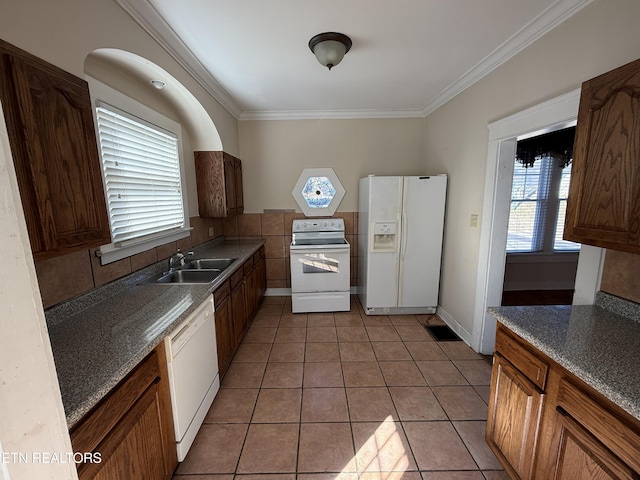 kitchen featuring white appliances, ornamental molding, sink, and light tile patterned floors