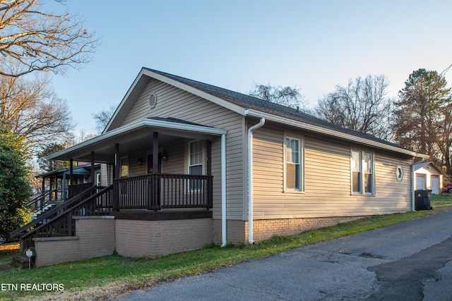 view of property exterior featuring a garage and covered porch