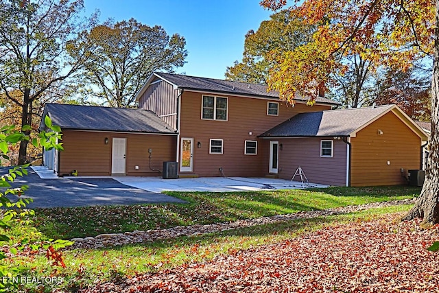 back of house featuring a patio, a yard, and central AC