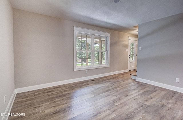 spare room featuring light wood-type flooring