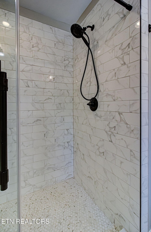 bathroom with a tile shower