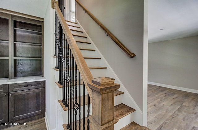 stairway with hardwood / wood-style flooring