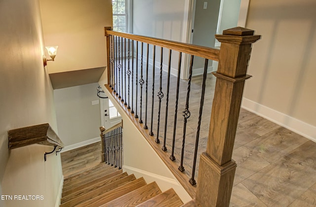 stairs featuring baseboards and wood finished floors