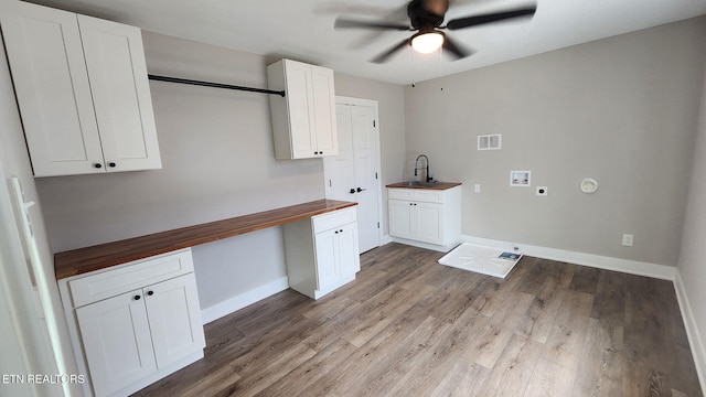 laundry area featuring washer hookup, light wood finished floors, cabinet space, visible vents, and a sink