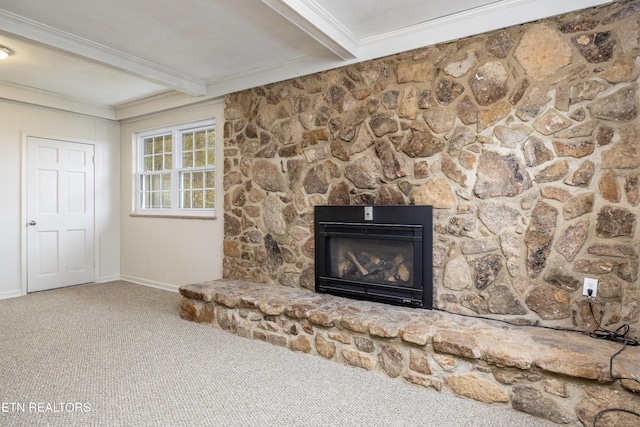 interior details featuring beam ceiling, a fireplace, ornamental molding, and carpet