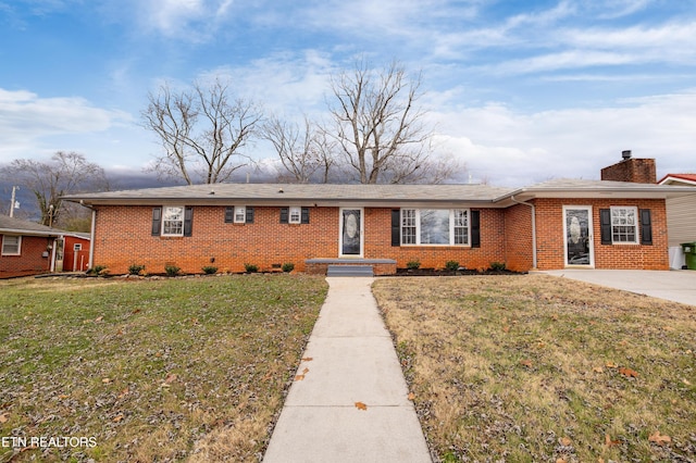 ranch-style house with a front lawn