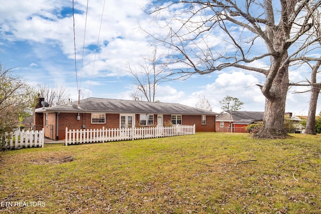 rear view of house with a lawn