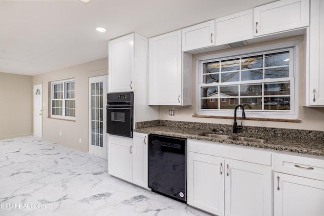 kitchen with white cabinetry, dark stone countertops, sink, and black appliances