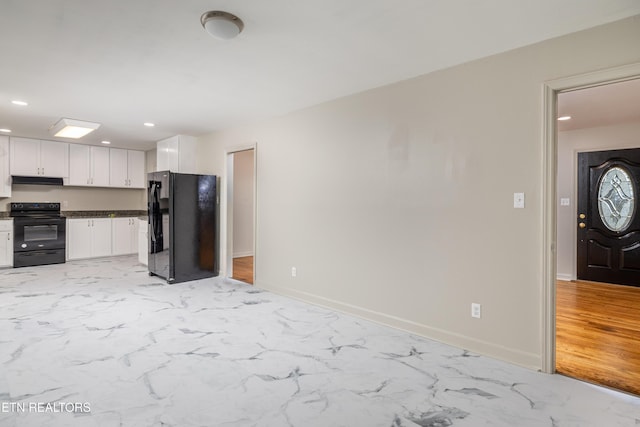 kitchen with black appliances and white cabinets