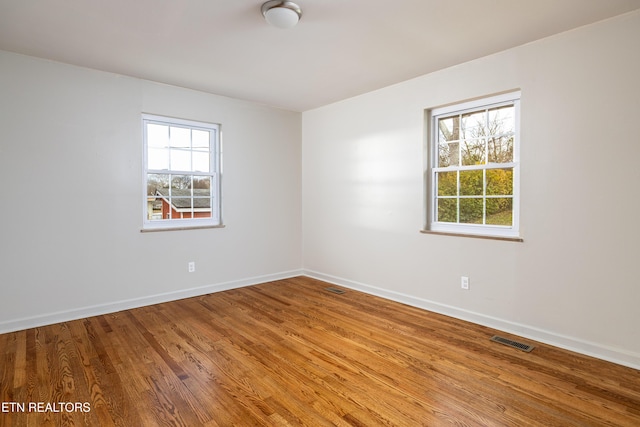 spare room featuring hardwood / wood-style flooring