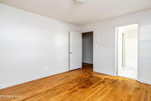 spare room with wood-type flooring