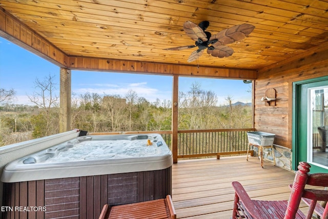 wooden terrace featuring a hot tub and ceiling fan