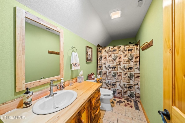 bathroom featuring tile patterned flooring, a shower with shower curtain, vanity, vaulted ceiling, and toilet