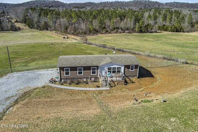 view of front of property with a rural view and a front yard