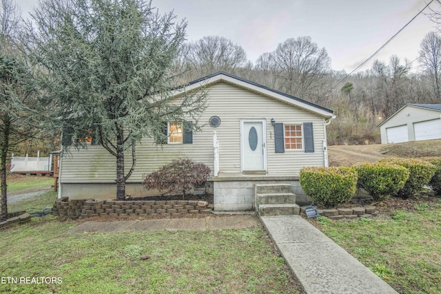 view of front of property featuring a garage and a front yard