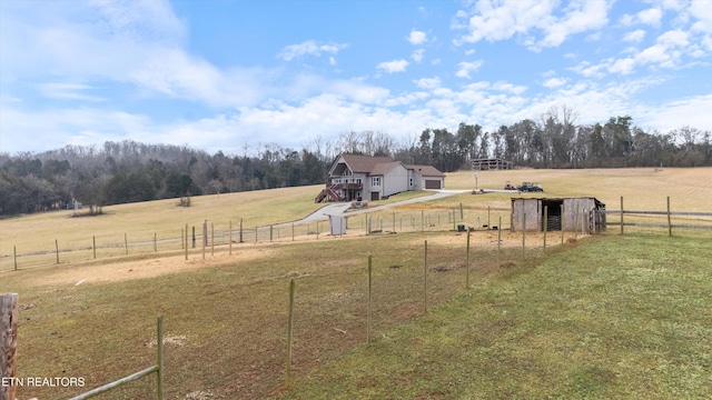 view of yard featuring an outdoor structure and a rural view