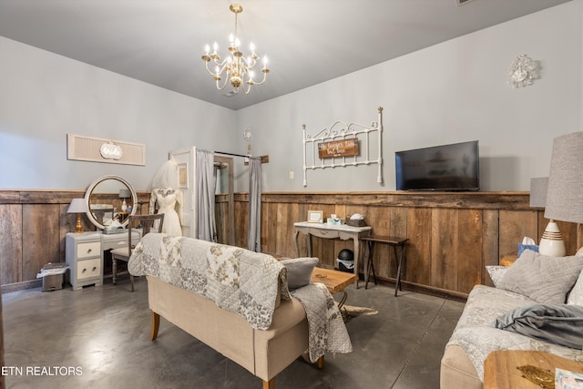 bedroom with a notable chandelier and wooden walls