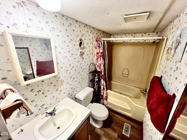 full bathroom with vanity, shower / bathtub combination with curtain, a textured ceiling, and toilet