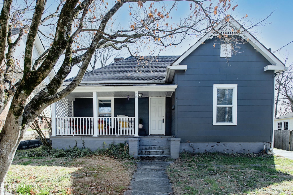 bungalow-style house with a front lawn and a porch