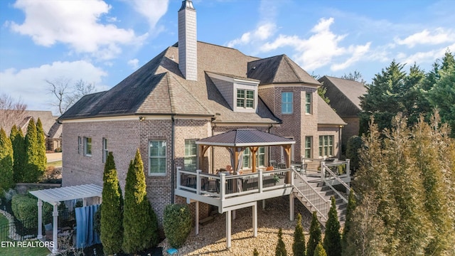 rear view of house featuring a gazebo, a wooden deck, and a pergola