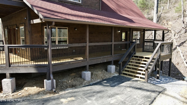 view of property exterior with a wooden deck