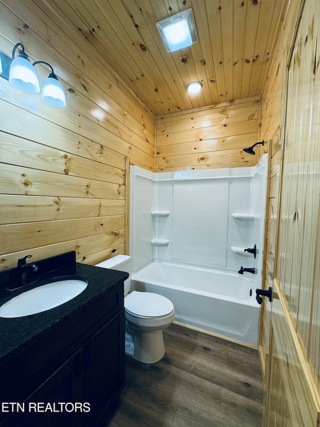 full bathroom with shower / bathing tub combination, wood-type flooring, vanity, wood ceiling, and toilet